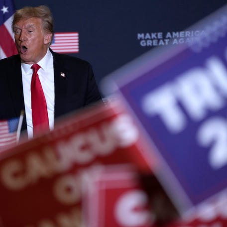 Former President Donald Trump walks off stage during a commit to caucus rally, Wednesday, Dec. 13, 2023, in Coralville, Iowa. (AP Photo/Charlie Neibergall)