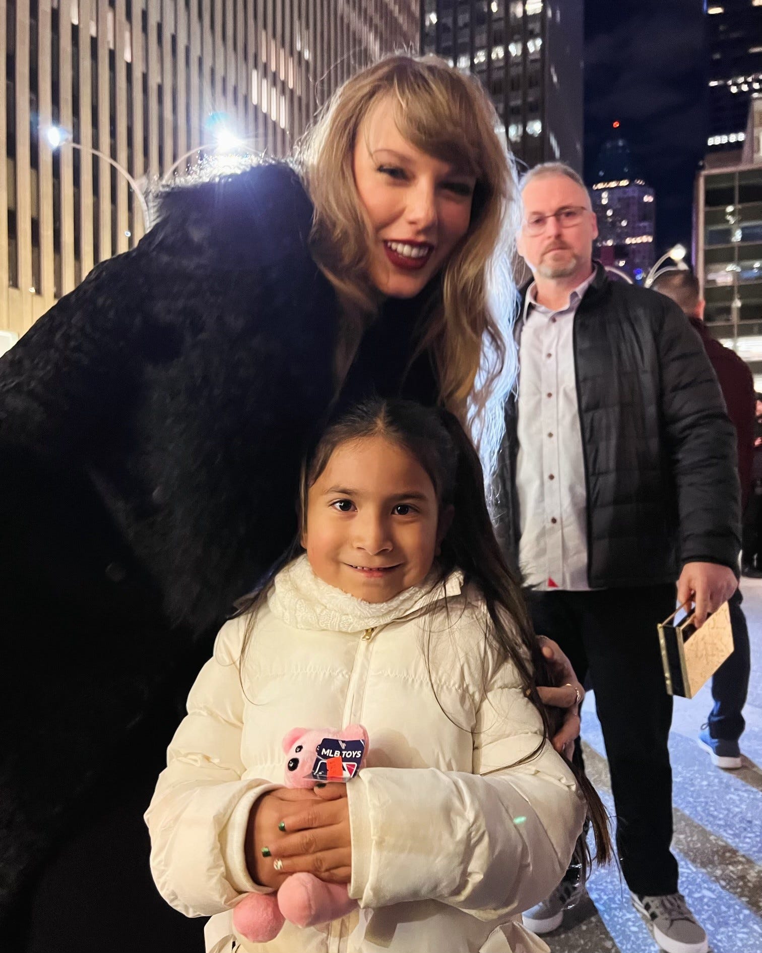 Taylor Swift poses with Natalie Rodriguez on a New York City sidewalk.