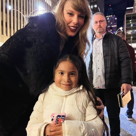 Taylor Swift poses with Natalie Rodriguez on a New York City sidewalk.