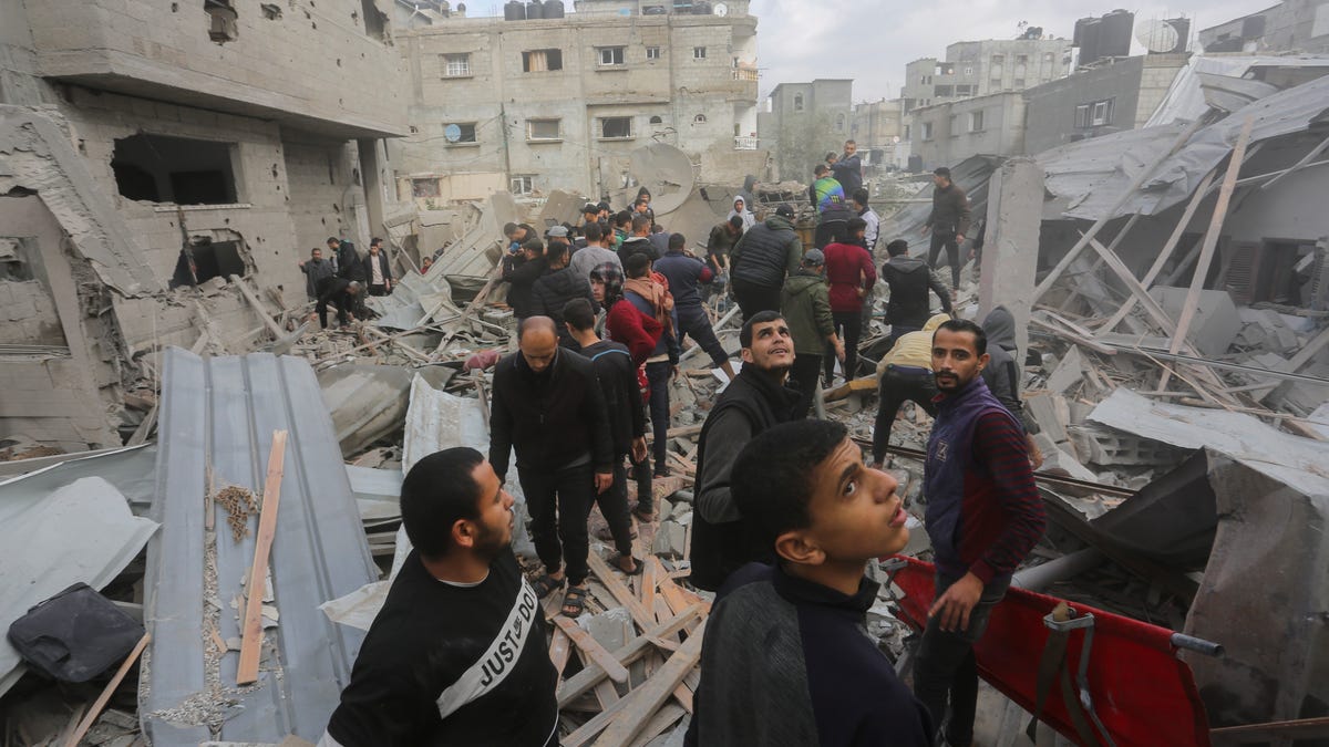 Palestinians look for the survivors of an Israeli strike in Rafah, Gaza Strip, Thursday, Nov. 14, 2023.