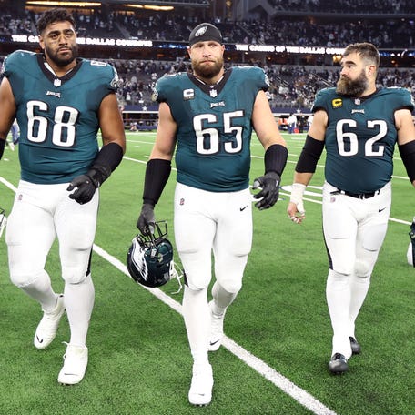 Philadelphia Eagles offensive tackle Jordan Mailata (68) and offensive tackle Lane Johnson (65) and center Jason Kelce (62) walk off the field after the game against the Dallas Cowboys at AT&T Stadium.