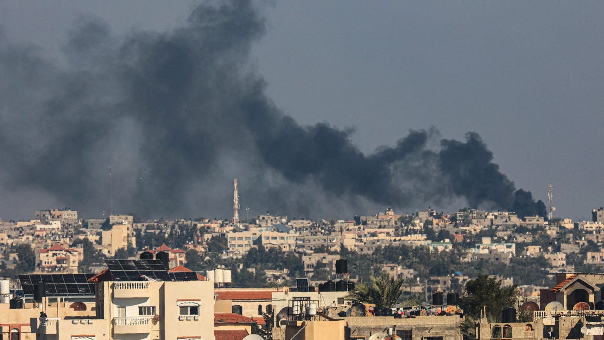 A picture taken from Rafah shows smoke billowing over Khan Yunis in the southern Gaza Strip following Israeli bombardment on Dec. 15, 2023, amid continuing battles between Israel and the Palestinian militant group Hamas.