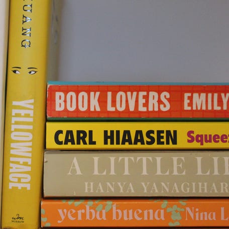 A selection of colorful books arranged on a bookshelf.