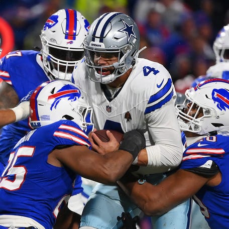Tyrel Dodson #25 and Greg Rousseau #50 both of the Buffalo Bills sack Dak Prescott #4 of the Dallas Cowboys during the third quarter at Highmark Stadium on December 17, 2023 in Orchard Park, New York.