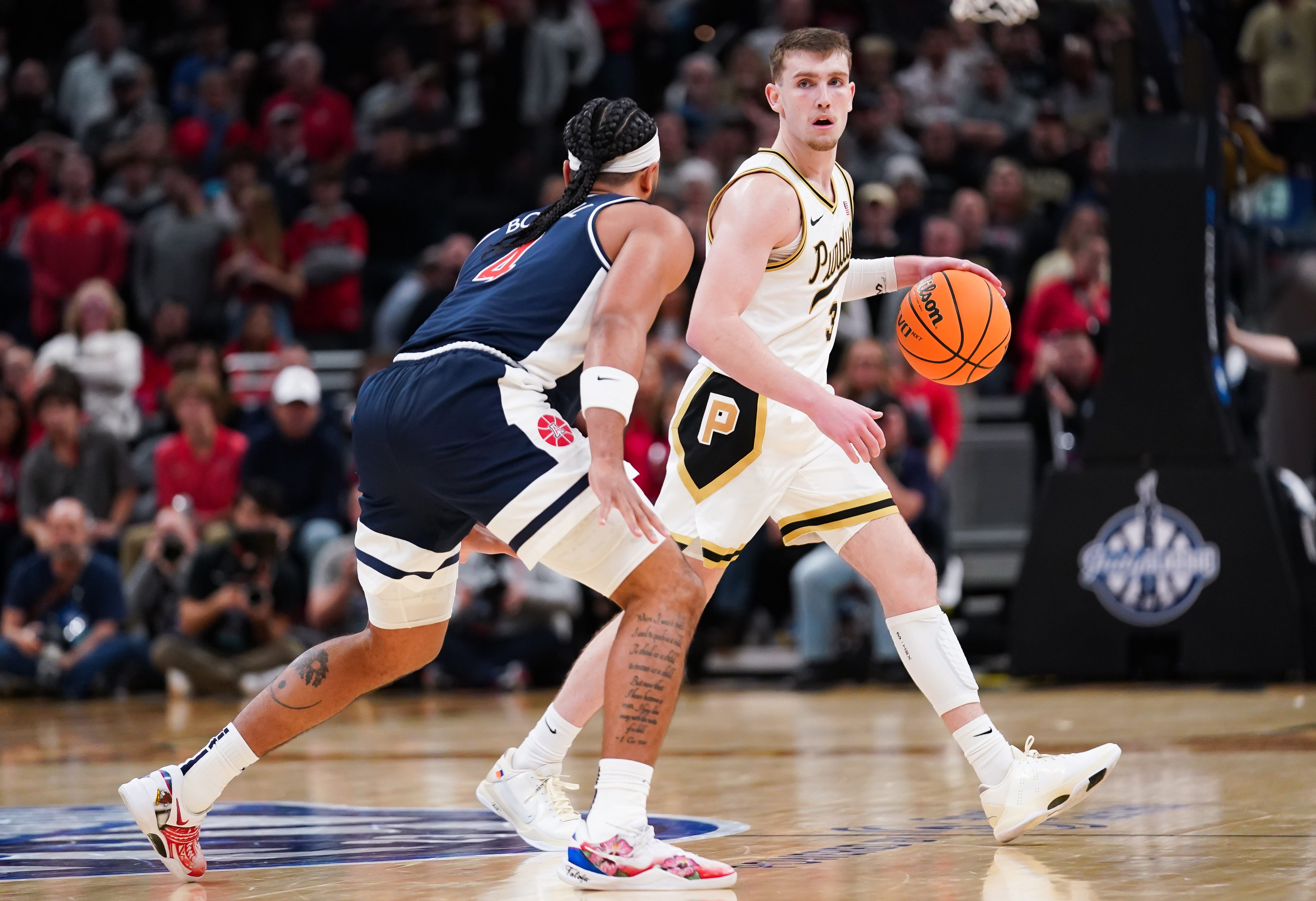 Purdue guard Braden Smith (3) dribbles against Arizona guard Kylan Boswell (4) during the second half at Gainbridge Fieldhouse.