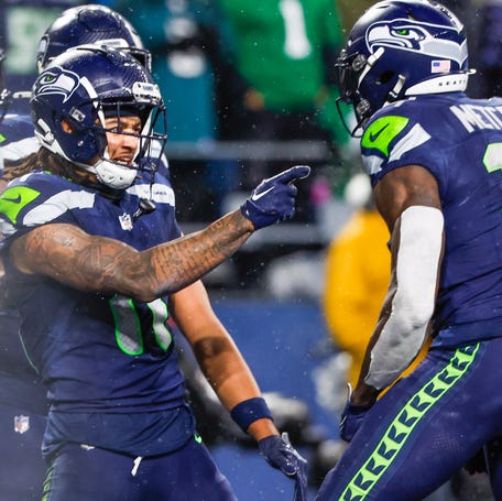 Seattle Seahawks wide receiver Jaxon Smith-Njigba (11) celebrates with wide receiver DK Metcalf (14) after catching a touchdown pass against the Philadelphia Eagles during the fourth quarter at Lumen Field.
