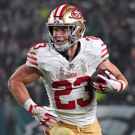 49ers running back Christian McCaffrey takes off with the ball against the Eagles at Lincoln Financial Field in Philadelphia on Dec. 3, 2023.