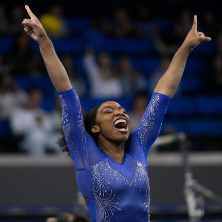 UCLA Bruins athlete Chae Campbell celebrates at the conclusion of her floor exercise routine at the NCAA Women's Gymnastics Los Angeles Regional at Pauley Pavilion.