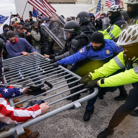 Insurrections loyal to President Donald Trump try to break through a police barrier, Wednesday, Jan. 6, 2021, at the Capitol in Washington. The Department of Justice is prosecuting those who violently stormed the Capitol.