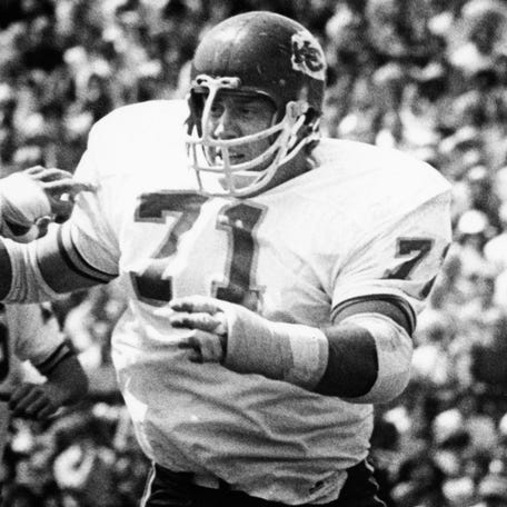 Kansas City Chiefs left guard Ed Budde (71) blocks against Chicago Bears defensive end Steve DeLong (87) as running back Ed Podolak (14) carries the ball at Soldier Field during the 1972 preseason.