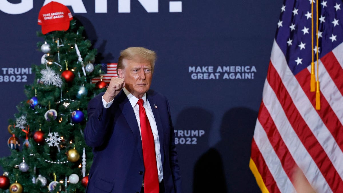 Former President and 2024 presidential hopeful Donald Trump gestures at the end of a campaign event in Waterloo, Iowa, on December 19, 2023.