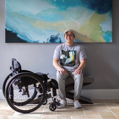 Sean Chang at home with his wheelchair.