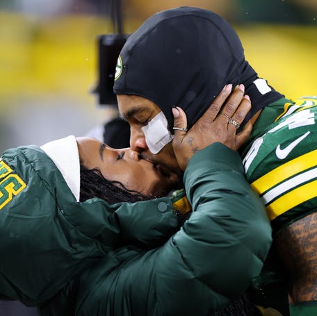 Olympic gold medalist Simone Biles kisses husband Jonathan Owens of the Green Bay Packers before the game against the Kansas City Chiefs on Dec. 3, 2023, at Lambeau Field.