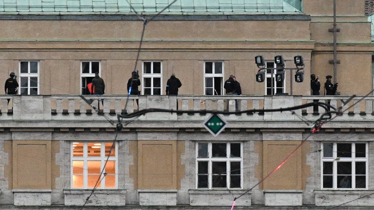 TOPSHOT - Armed police are seen on the balcony of the Charles University in central Prague, on December 21, 2023. Czech police said a shooting in a university building in central Prague has left "dead and wounded people", without providing further details.    "Based on the initial information we have, we can confirm dead and wounded people on the scene," police said on X, formerly Twitter. Czech media said the shooting had occurred at the Faculty of Arts whose teachers and students were instructed to lock themselves up as the police action was under way. (Photo by Michal CIZEK / AFP) (Photo by MICHAL CIZEK/AFP via Getty Images) ORIG FILE ID: 1865040319