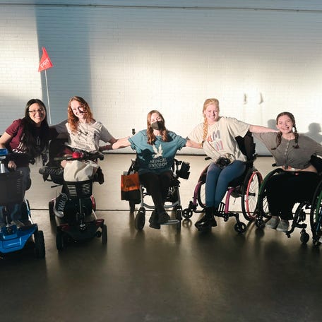 Lydia Barron (third from right with pink wheelchair push rims) with a group of friends.
