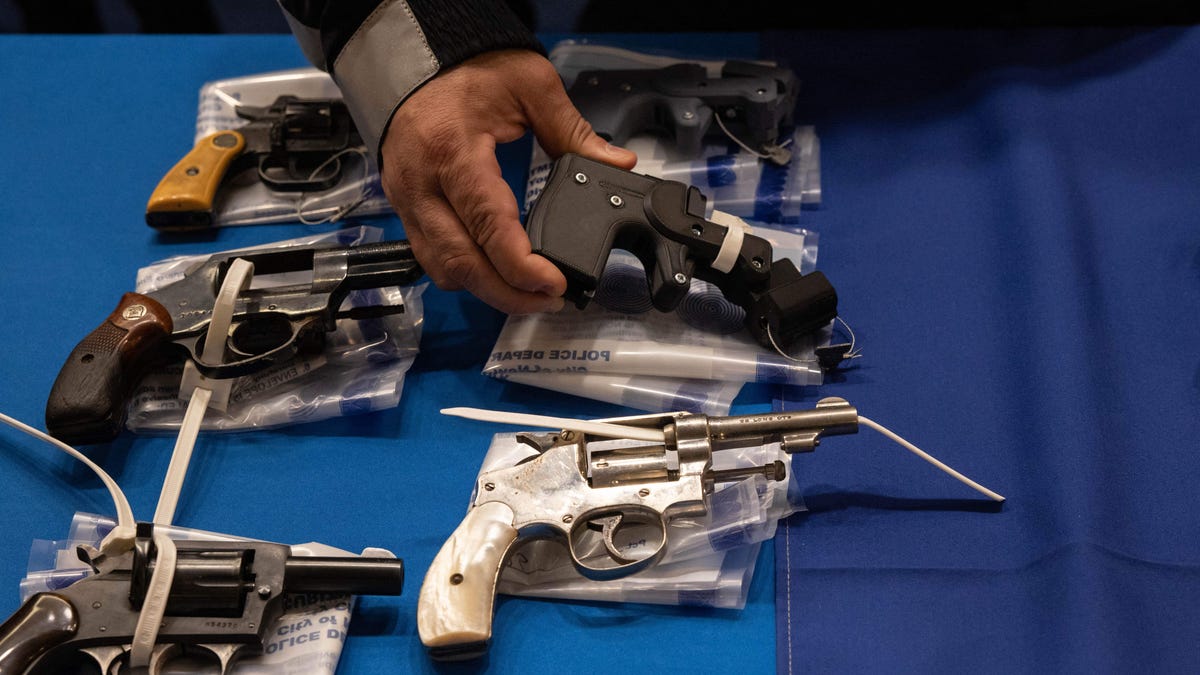 Kings County District Attorney Eric Gonzalez holds a 3D printed ghost gun during a statewide gun buyback event held by the office of the New York State Attorney General, in the Brooklyn borough of New York on April 29, 2023.