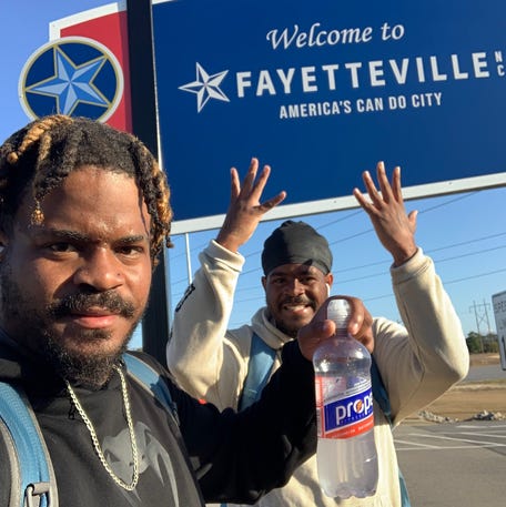 Davon and Tavon Woods pose as they make it to Fayetteville, North Carolina. The twins are walking to raise awareness of the challenges faced by children in foster care. They're expecting to make it to Philadelphia on Dec. 31.