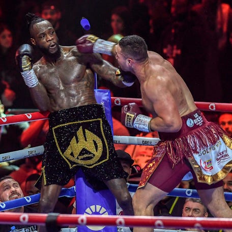 Joseph Parker throws a punch at Deontay Wilder during their boxing match at Kingdom Arena in Riyadh, Saudi Arabia.