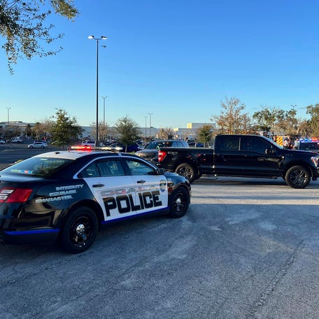 In this photo provided by the Ocala Police Department, a cruiser sits parked following a fatal shooting at Paddock Mall in Ocala, Fla., located about 80 miles northwest of Orlando, Saturday, Dec. 23, 2023. (Jeff Walczak/Ocala Police Department via AP) ORG XMIT: NYSB602