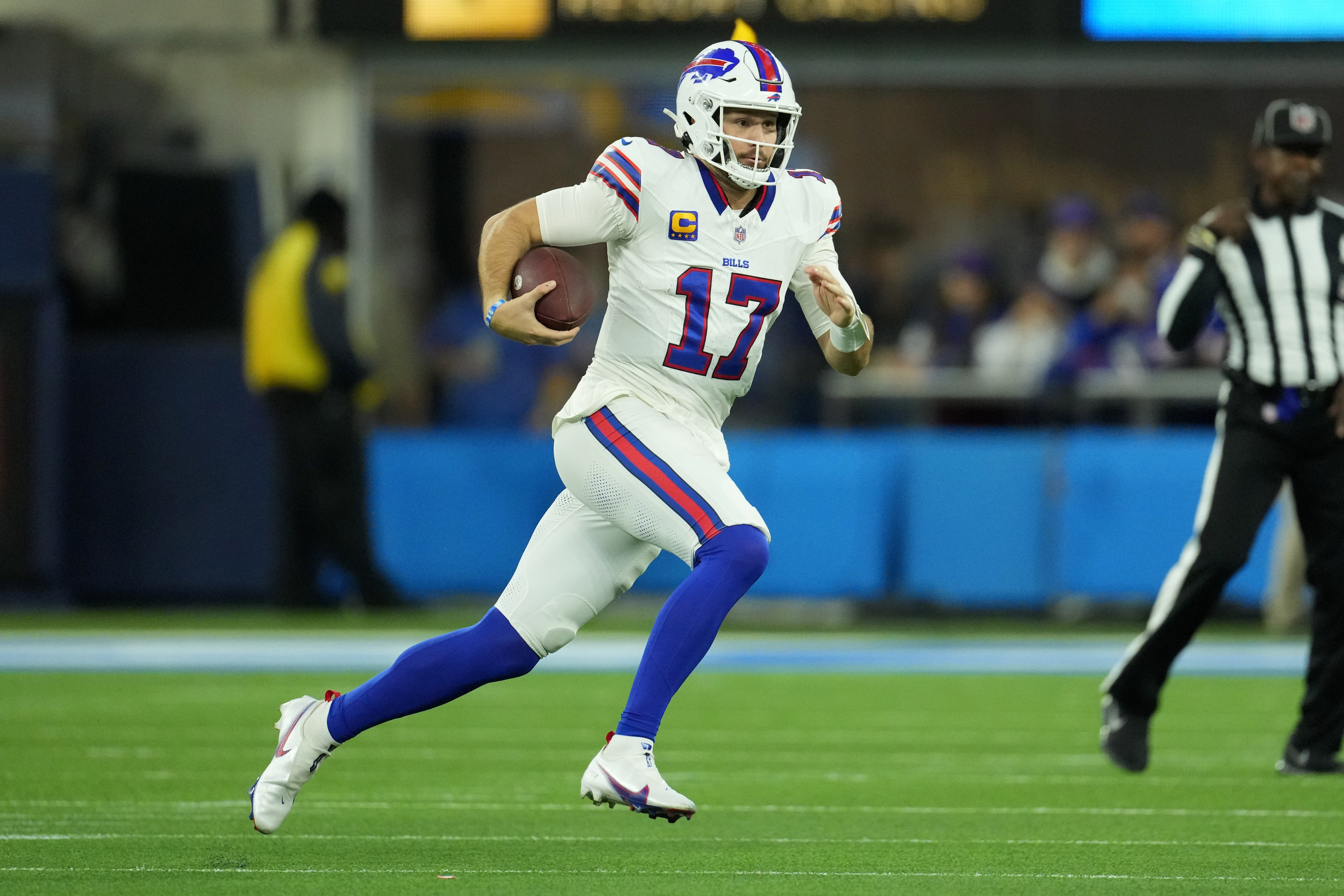 Dec 23, 2023; Inglewood, California, USA; Buffalo Bills quarterback Josh Allen (17) carries the ball against the Los Angeles Chargers in the first half at SoFi Stadium. Mandatory Credit: Kirby Lee-USA TODAY Sports