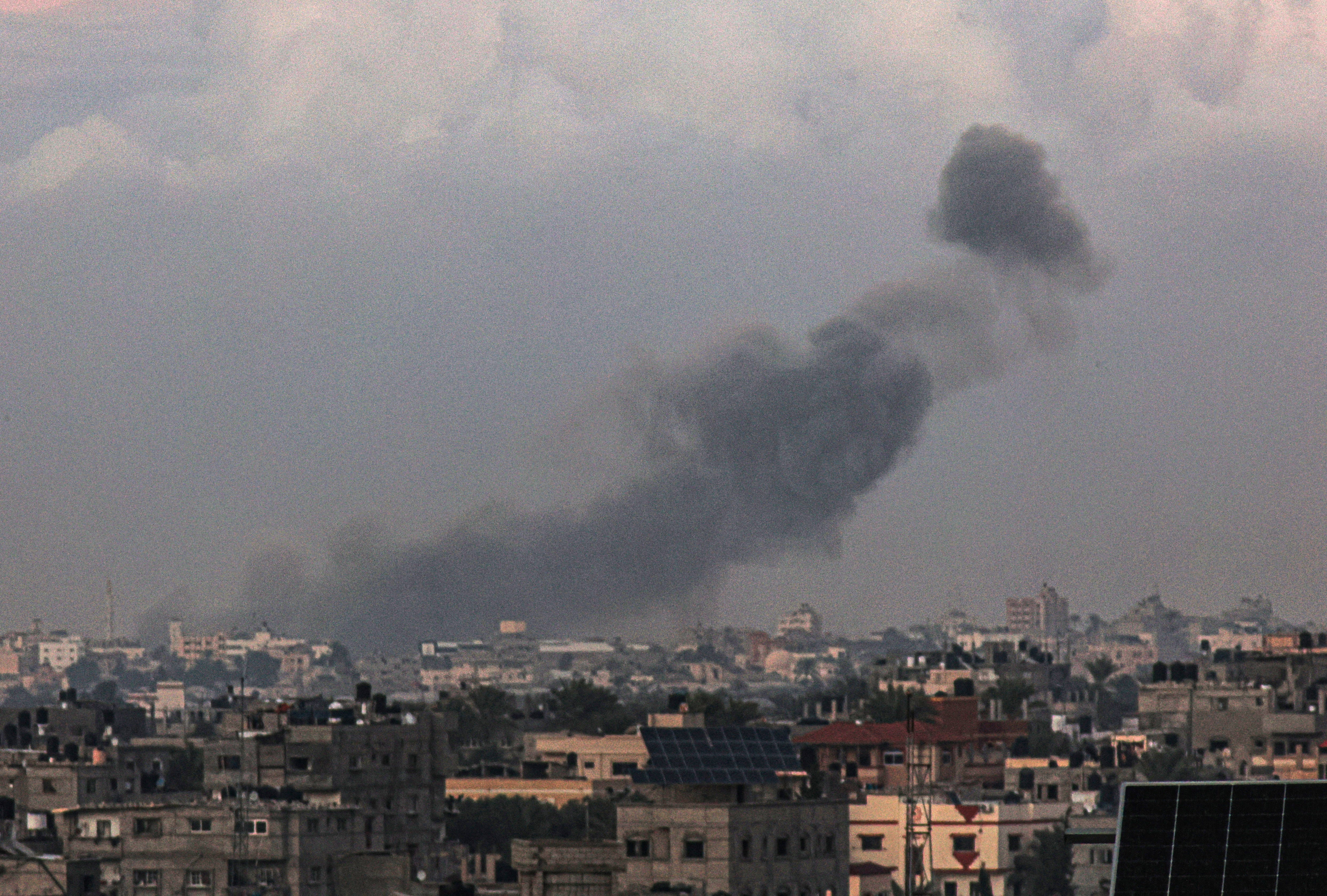 A picture taken from Rafah shows smoke billowing over Khan Younis during Israeli bombardment in the southern Gaza Strip on Dec. 24, 2023.