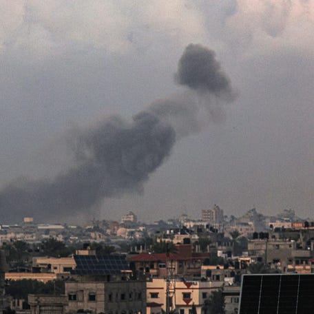 A picture taken from Rafah shows smoke billowing over Khan Younis during Israeli bombardment in the southern Gaza Strip on Dec. 24, 2023.