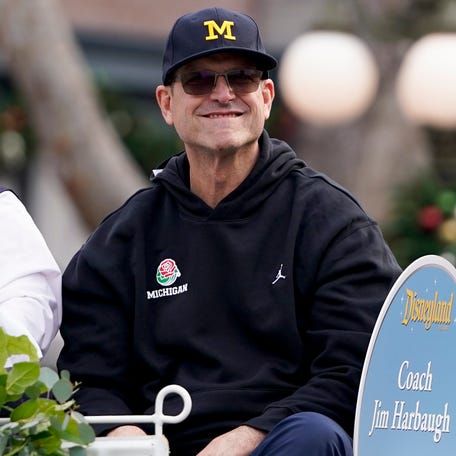 Michigan coach Jim Harbaugh smiles during a welcome event for the team at Disneyland.