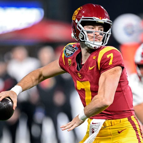 USC quarterback Miller Moss (7) throws a pass against Louisville during the Holiday Bowl.