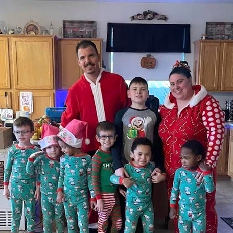 In this photo provided by Karen Lopez, she and her husband, Jerry Lopez, are seen with their seven children in December 2023. Jerry Lopez, 39, was killed in Las Vegas two days after Christmas while on his way to work in what Las Vegas police say was the final carjacking in a crime spree. (Karen Lopez via AP)
