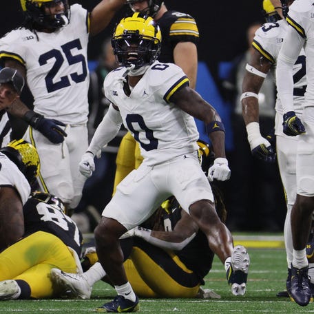 Michigan defensive back Mike Sainristil (0) reacts after a play during the first half of the Big Ten championship game against Iowa at Lucas Oil Stadium.