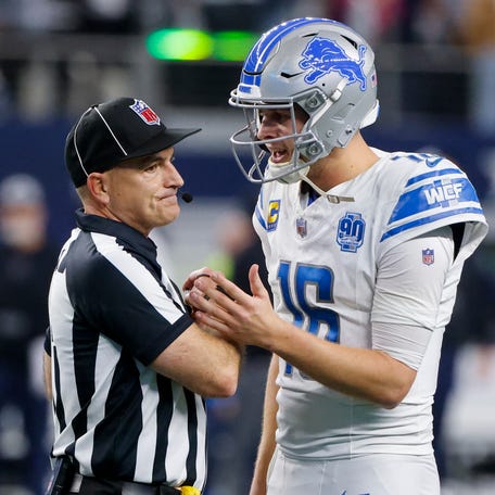 Detroit Lions quarterback Jared Goff (16) talks with umpire Duane Heydt after a two-point conversion play by the Lions.