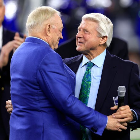 Former head coach Jimmy Johnson (R) talks with owner Jerry Jones (L) during the Dallas Cowboys Ring of Honor ceremony at halftime in the game between the Detroit Lions and the Dallas Cowboys at AT&T Stadium on December 30, 2023 in Arlington, Texas.