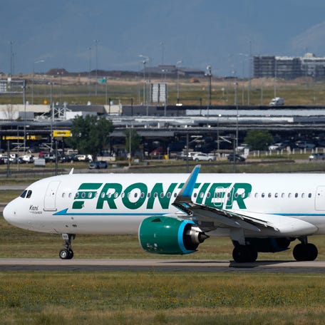 A Frontier Airlines jetliner waits on a runway for departure from Denver International Airport, Sept. 1, 2023.