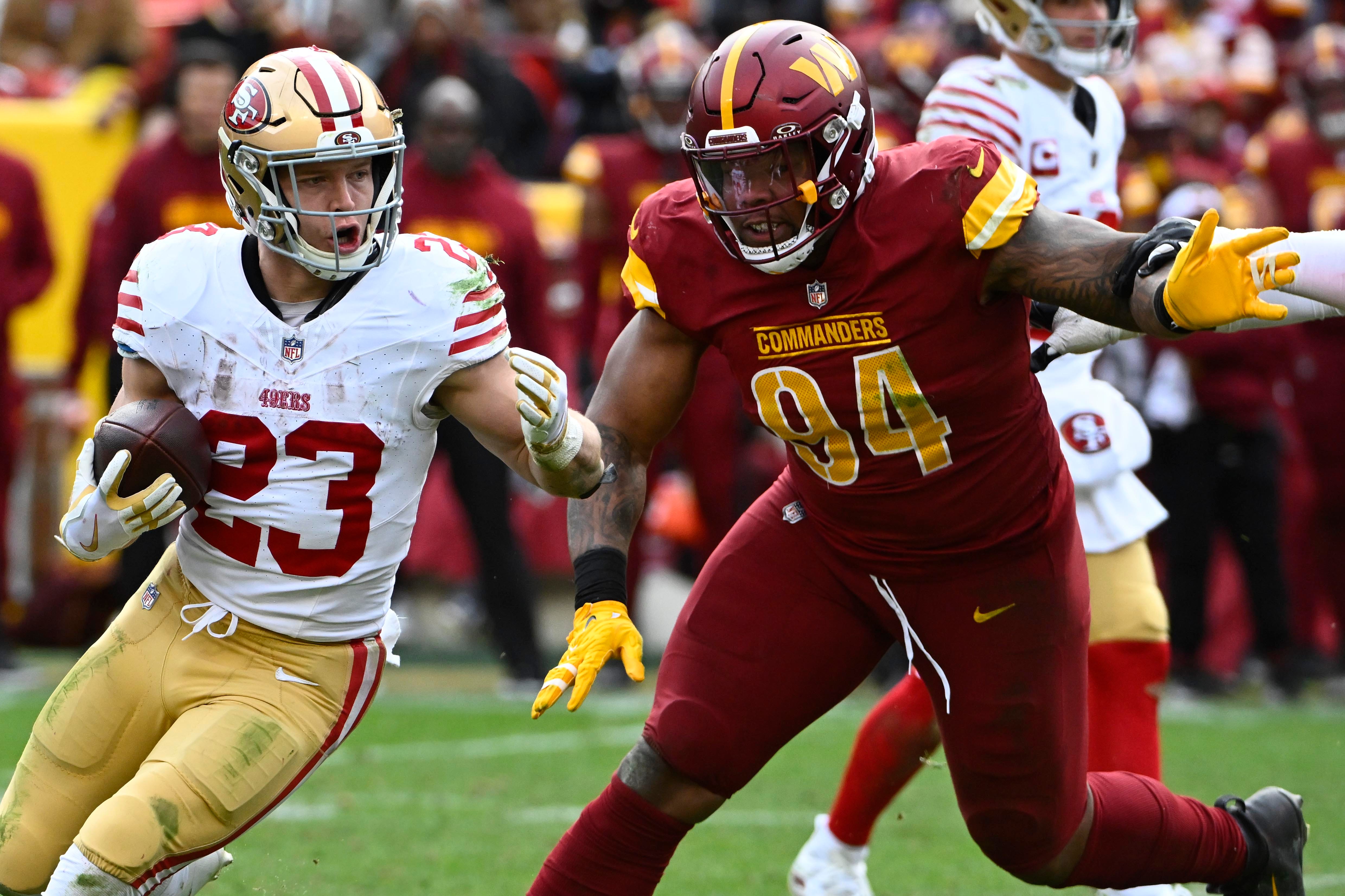San Francisco 49ers running back Christian McCaffrey (23) carries the ball as Washington Commanders defensive tackle Daron Payne (94) pursues.