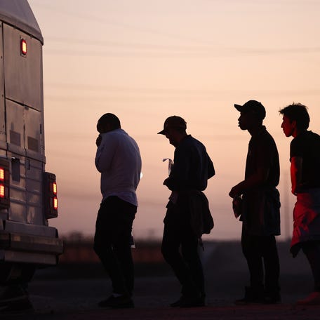 YUMA, ARIZONA - MAY 11: Immigrants seeking asylum, wait to board a bus to a U.S. Border Patrol processing center, after crossing into Arizona from Mexico, on May 11, 2023 in Yuma, Arizona. A surge of immigrants is expected with today's end of the U.S. government's Covid-era Title 42 policy, which for the past three years has allowed for the quick expulsion of irregular migrants entering the country. Over 29,000 immigrants are currently in the custody of   U.S. Customs and Border Protection ahead of the sunset of the policy tonight. (Photo by Mario Tama/Getty Images)
