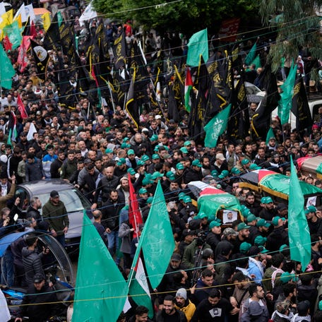People attend the funeral for Saleh Arouri, one of the top Hamas commanders, and two other Hamas members, who were killed in an apparent Israeli strike Tuesday, during his funeral in Beirut, Lebanon, Thursday, Jan. 4, 2024.
