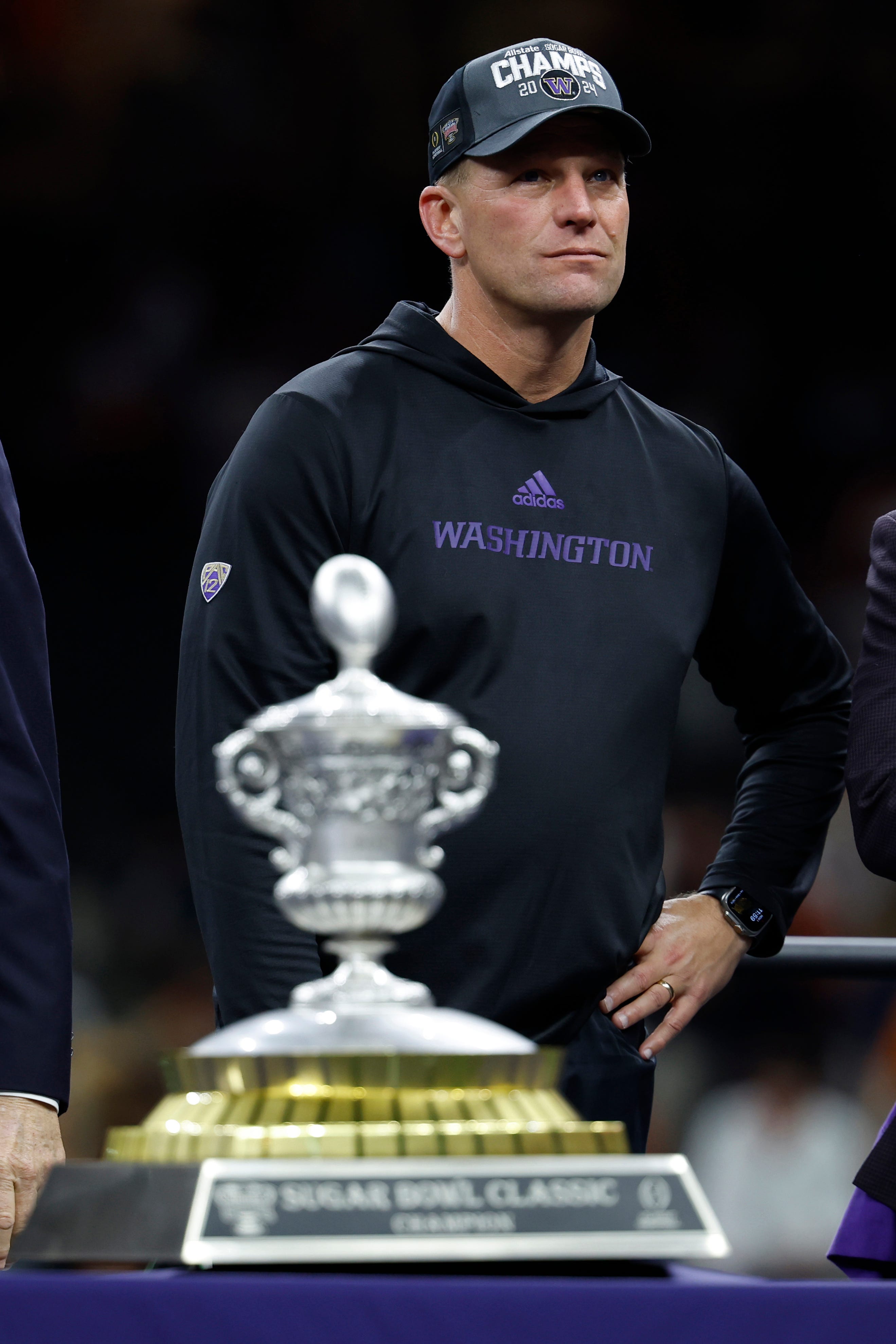 Kalen DeBoer stands on the stage during the Sugar Bowl championship trophy presentation after Washington defeated Texas.