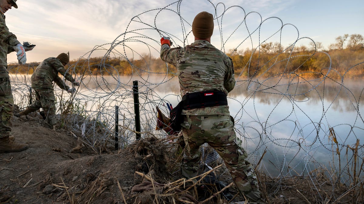 Texas National Guard soldiers install additional razor wire lie along the Rio Grande on January 10, 2024 in Eagle Pass, Texas. Following a major surge of migrant border crossings late last year, miles of razor wire as well as huge quantities of refuse remain along the U.S.-Mexico border at Eagle Pass.
