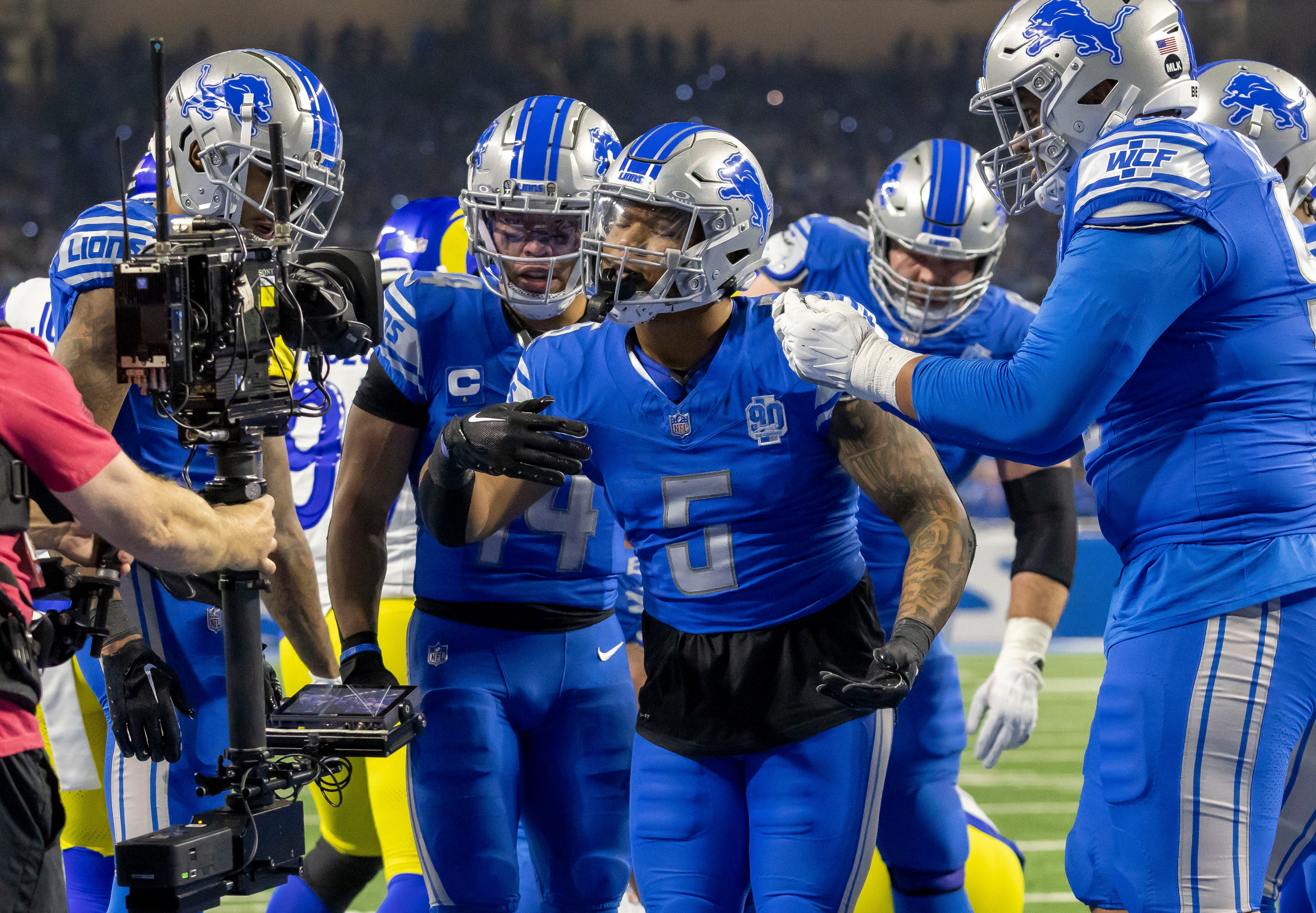 Detroit Lions running back David Montgomery (5) celebrates with teammates after scoring a touchdown.