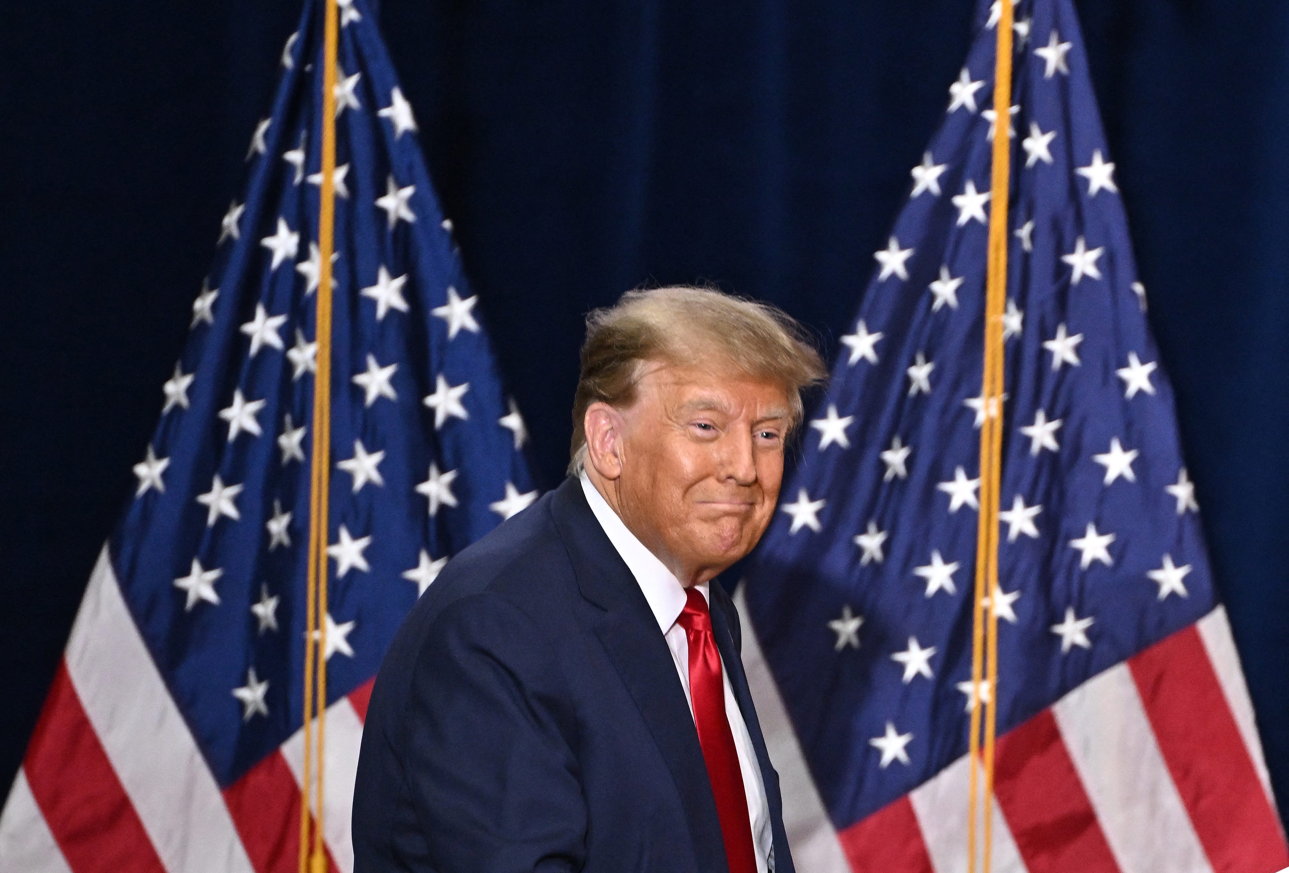 TOPSHOT - Former US President and Republican presidential hopeful Donald Trump arrives to speaks at a watch party during the 2024 Iowa Republican presidential caucuses in Des Moines, Iowa, on January 15, 2024. Trump told Americans Monday "it is time for our country to come together" after he won the Iowa caucuses, cementing his status as the likely Republican challenger to take on President Joe Biden in November's election. (Photo by Jim WATSON / AFP)   (Photo by JIM WATSON/AFP via Getty Images) ORG XMIT: 776087398 ORIG FILE ID: 1928401654
