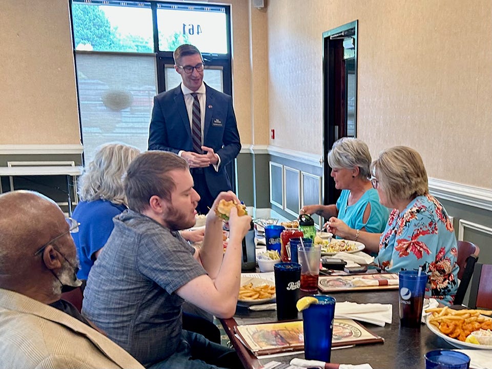 Matt Shoemaker, a Republican who is running for a U.S. House seat to represent North Carolina's 13th Congressional District, talks to a group of prospective voters at a restaurant.