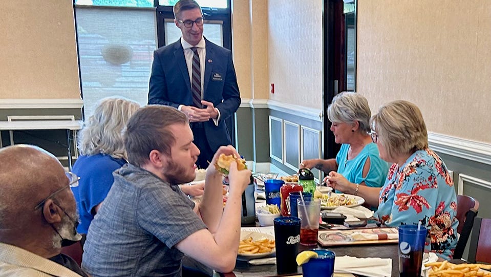 Matt Shoemaker, a Republican who is running for a U.S. House seat to represent North Carolina's 13th Congressional District, talks to a group of prospective voters at a restaurant.