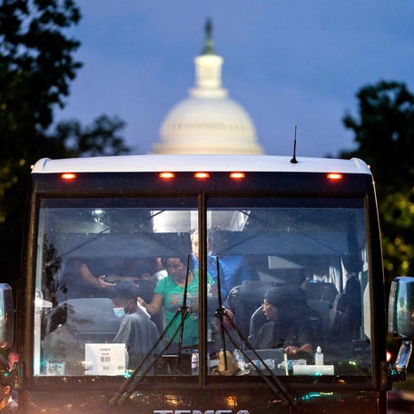 Migrants who boarded a bus in Texas are dropped off within view of the US Capitol building in Washington, DC, on Aug. 11, 2022. - Since April, Texas Governor Greg Abbott has ordered buses to carry thousands of migrants from Texas to Washington, DC, and New York City to highlight criticisms of US President Joe Biden's border policy,