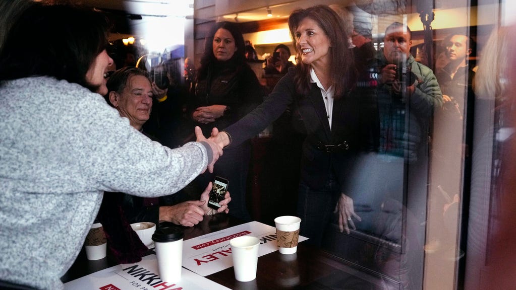 Republican presidential candidate former UN Ambassador Nikki Haley, seen through a storefront window, shakes hands with guests while visiting Kay's Bakery and Cafe, during a campaign stop, Friday, Jan. 19, 2024, in Hampton, N.H. (AP Photo/Charles Krupa) ORG XMIT: NHCK108