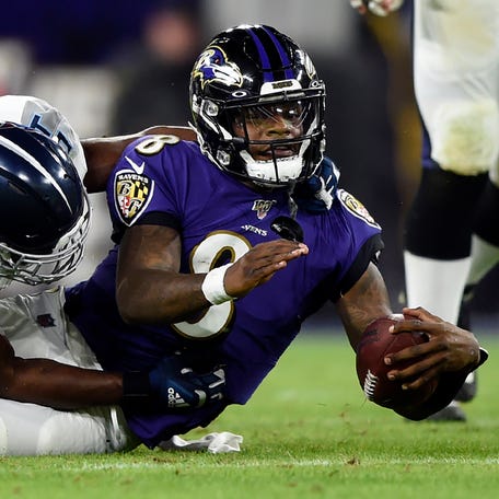 FILE - Baltimore Ravens quarterback Lamar Jackson (8) is tackled during the second half an NFL divisional playoff football game against the Tennessee Titans, Jan. 11, 2020, in Baltimore. The last time the Ravens were the top seed in the AFC was four years ago. Led by MVP Jackson, Baltimore went 14-2. Then the Ravens faltered and lost their playoff opener 28-12 to the Titans. (AP Photo/Gail Burton, File) ORG XMIT: NY905
