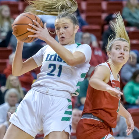 Peoria Notre Dame's Kaitlin Cassidy (21) pulls down a rebound over Lincoln's Taryn Stoltzenburg in the first half of their nonconference basketball game Saturday, Jan. 20, 2024 at Renaissance Coliseum in Peoria. The Irish fell to the Railsplitters 63-52.