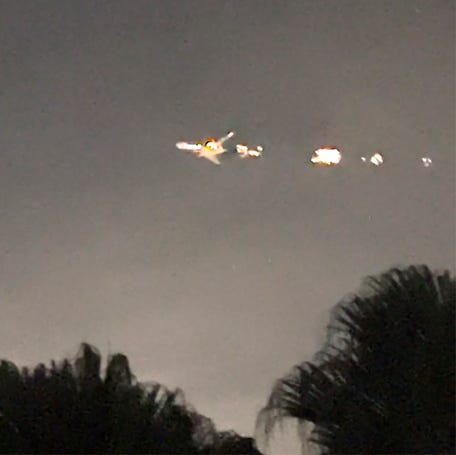 This image taken from video provided by Melanie Adaros shows sparks shooting from a cargo plane before making an emergency landing at Miami International Airport on Thursday, Jan. 18, 2024 in Miami.