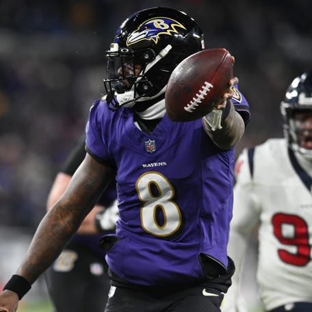 Lamar Jackson scores a touchdown during the divisional playoff win against the Houston Texans.