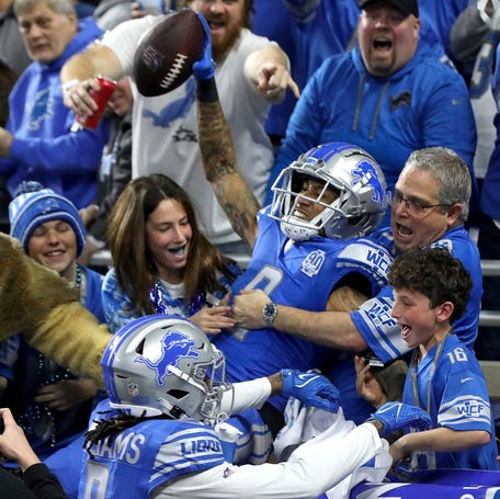 Detroit Lions wide receiver Josh Reynolds celebrates with fans after scoring a touchdown against the Tampa Bay Buccaneers in the divisional playoffs.
