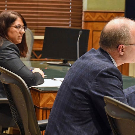 North Dakota Special Assistant Attorney General Dan Gaustad, right, argues before South Central District Judge Bruce Romanick, not pictured, during a December hearing in Bismarck, North Dakota over the state's revised abortion laws. At left is Meetra Mehdizadeh, attorney for the Center for Reproductive Rights, who argued on behalf of the Red River Women's Clinic, which has sued over the abortion ban.